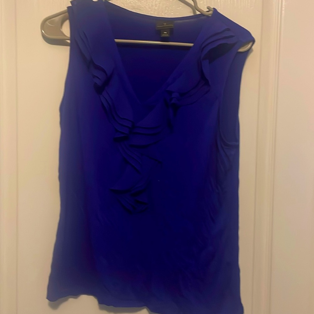 Royal blue blouse with a ruffle detail along the collar.